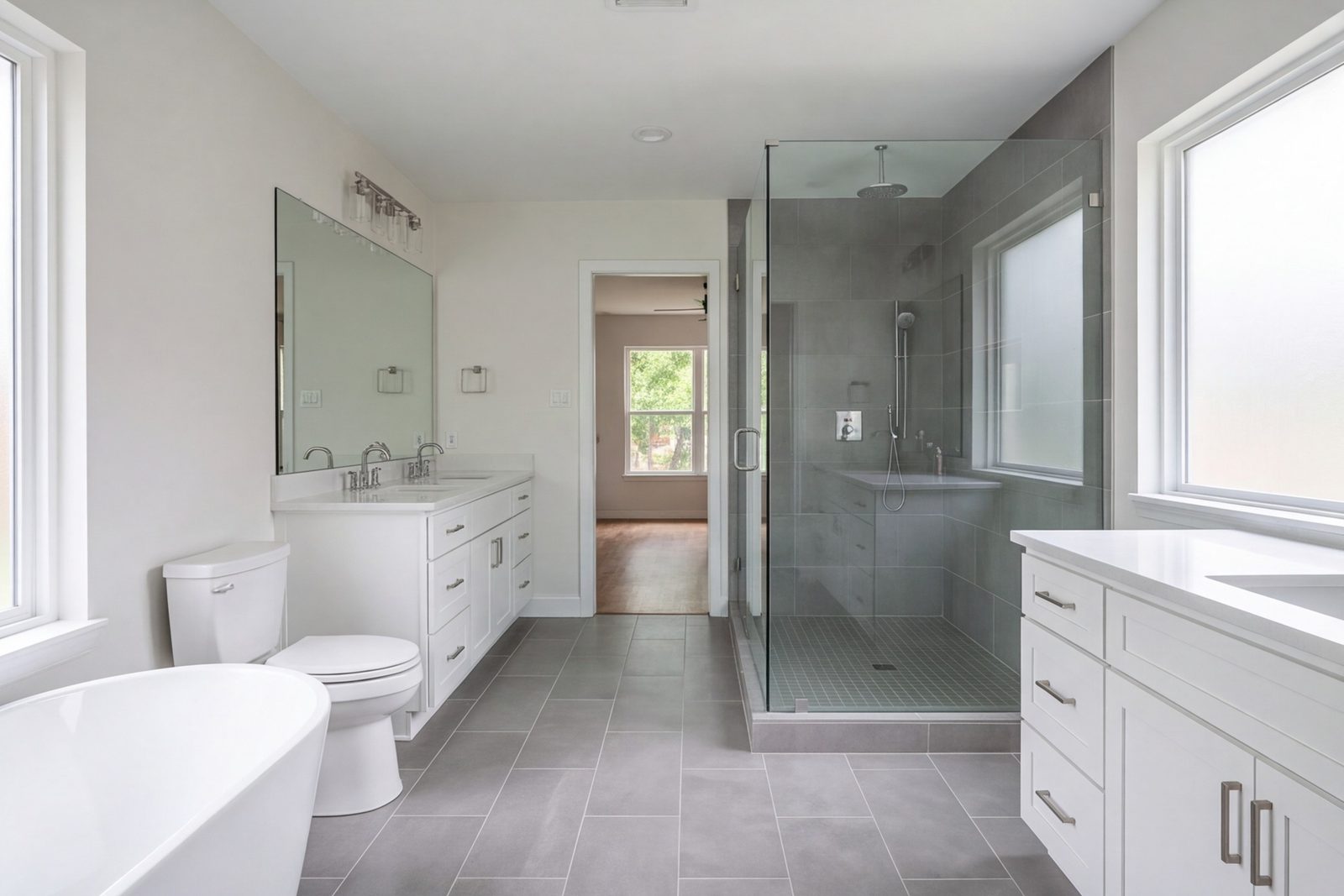 Northwood Hills primary bath with a walk-in shower, double vanity and wide floor tile